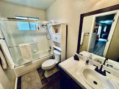 a bathroom with a sink and a shower and a toilet at Lighthouse Suite Pet Friendly Hot Tub Sleeps 4 in Coarsegold