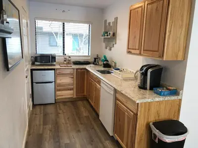 a kitchen with wooden cabinets and a counter top at Owl Nest Hot Tub Sleeps 3 Yosemite in Ahwahnee