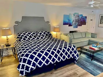 a bedroom with a blue and white bed and a couch at Owl Nest Hot Tub Sleeps 3 Yosemite in Ahwahnee