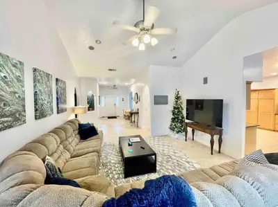 a living room with a large couch and a piano at Peacock Suite Hot Tub Sleeps up to 4 Bbq in Ahwahnee