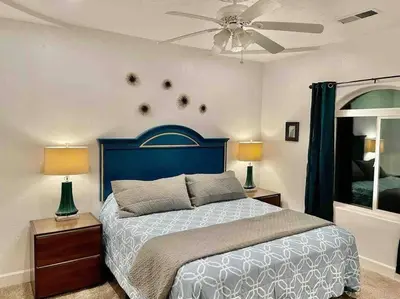 a bedroom with a bed and a ceiling fan at Peacock Suite Hot Tub Sleeps up to 4 Bbq in Ahwahnee
