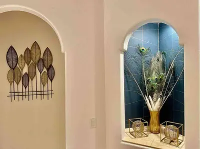a hallway with two mirrors and a vase with feathers at Peacock Suite Hot Tub Sleeps up to 4 Bbq in Ahwahnee