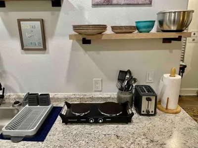 a kitchen counter with a stove and a counter top withtools at Quail Suite HOT TUB BBQ Sleeps 2 in Ahwahnee