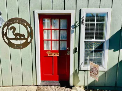 a red door on a building with a turkey sign on it at Squirrel View Hot tub BBQ Patio Shuffle Board in Oakhurst