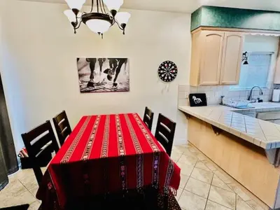 a kitchen with a table with a red tablecloth on it at Wild Stallion HOT TUB Sleeps 4 Darts Private in Ahwahnee