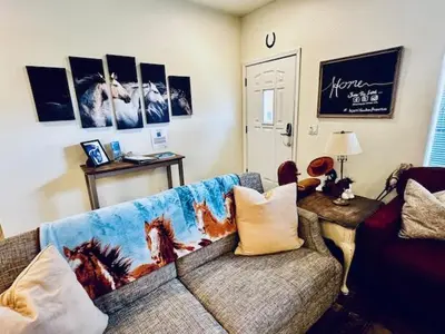 a living room with a couch and a table at Wild Stallion HOT TUB Sleeps 4 Darts Private in Ahwahnee