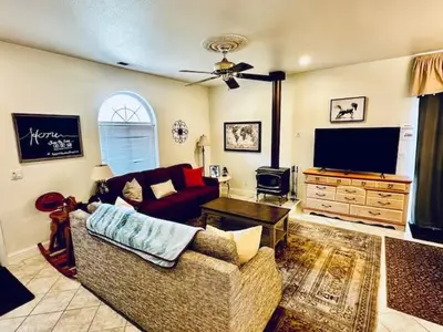 a living room with a couch and a flat screen tv at Wild Stallion HOT TUB Sleeps 4 Darts Private in Ahwahnee