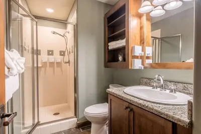 a bathroom with a toilet and a sink and a shower at Woodwinds 32 in Mammoth Lakes