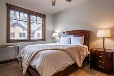 a bedroom with a large bed and a window at Woodwinds 32 in Mammoth Lakes