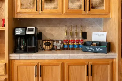 a kitchen counter with bottles of coffee on it at Yosemite Villa - log cabin with spectacular views & stargazing in Mariposa