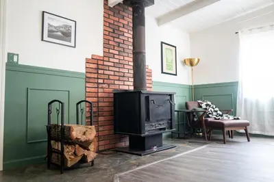 a fireplace in a living room with a stove at Peaceful Mariposa Home near Yosemite National Park in Mariposa
