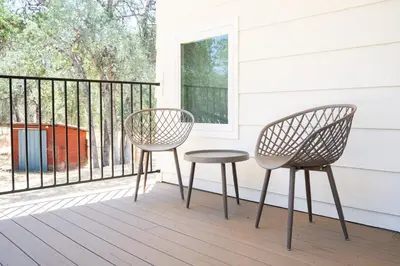 two chairs and a table on a porch at Peaceful Mariposa Home near Yosemite National Park in Mariposa