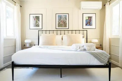 a bedroom with a bed with white sheets and pillows at Peaceful Mariposa Home near Yosemite National Park in Mariposa