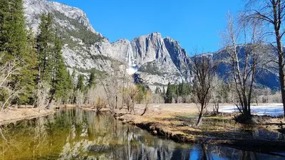 a river with a mountain in the background at Yosemite Mountain Retreat in Oakhurst