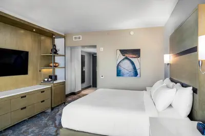 a bedroom with a large white bed and a tv at Red Hawk Resort & Casino in Placerville