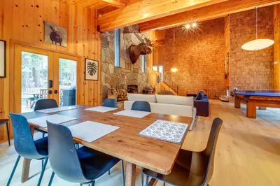 a dining room with a table and a pool table at 5 Mi to Donner Lake Cabin with Deck and Pool Access! in Truckee