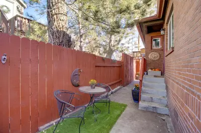 a patio with a table and chairs next to a fence at Hot Tub and Grill Pet-Friendly Apt, Walk to Midtown in Reno