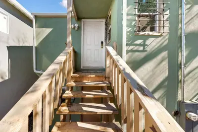 a wooden staircase leading to the front door of a house at Cozy 1bdr/1br home near downtown in Sacramento