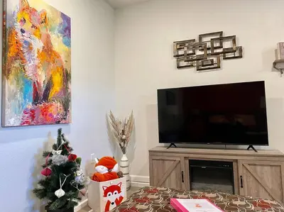 a living room with a television and a christmas tree at Foxs Den Hot Tub Bbq Queen Bed Sleeps 2 in Ahwahnee