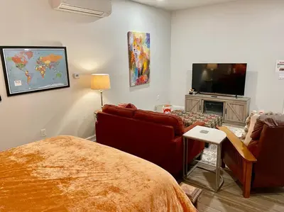 a living room with a bed and a tv at Foxs Den Hot Tub Bbq Queen Bed Sleeps 2 in Ahwahnee