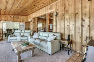 a living room with a couch and a table at Spacious Coarsegold Getaway about 34 Mi to Yosemite! in Coarsegold