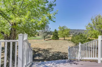 a white fence with a view of a yard at Spacious Coarsegold Getaway about 34 Mi to Yosemite! in Coarsegold