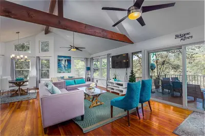 a living room with a ceiling fan and blue chairs at **Kaweah River House** - 1/2 Mile to Sequoia Park in Three Rivers