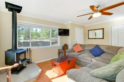 a living room with a couch and a wood stove at Groveland Vacation Rental with Private Deck and Grill! in Groveland