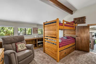 a bedroom with a bunk bed and a desk at Water's Edge - Gorgeous Water Views! home in Groveland