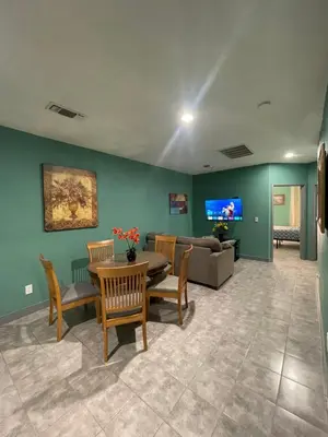 a living room with a couch and a table and chairs at Fresno Vacation Rental 106 in Fresno