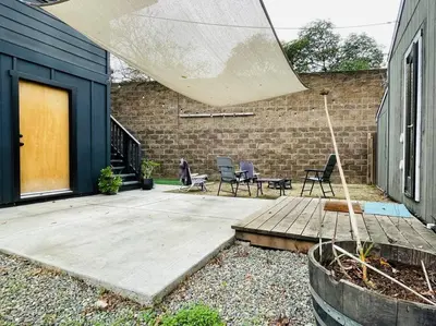 a patio with chairs and a table and a building at Artist's retreat near the heart of the city in Sacramento
