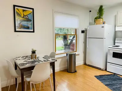 a kitchen with a table and a white refrigerator at Artist's retreat near the heart of the city in Sacramento