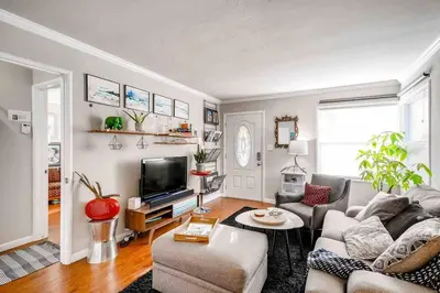 a living room with a couch and a tv at Smart Eclectic ART HOUSE near the beat in Sacramento
