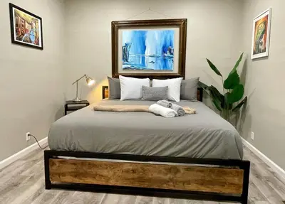 a bedroom with a large bed in a room at Artists Bungalow ARCADE King Beds near the beat in Sacramento