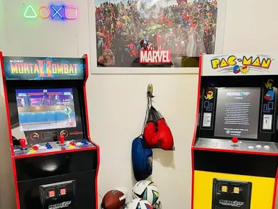 two video game machines sitting next to each other at Artists Bungalow ARCADE King Beds near the beat in Sacramento