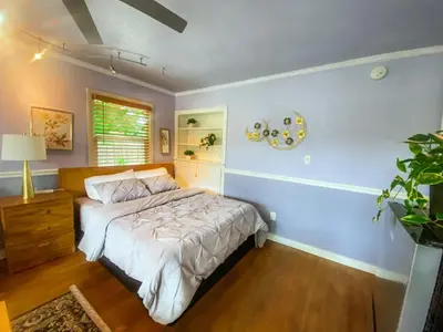 a bedroom with a bed and a blue wall at Sweet Home with Ample Parking Only 2mins to Freeway in Sacramento