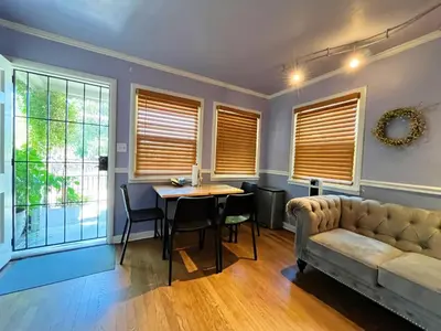 a living room with a table and a couch at Sweet Home with Ample Parking Only 2mins to Freeway in Sacramento