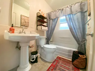 a bathroom with a sink and a toilet and a window at Sweet Home with Ample Parking Only 2mins to Freeway in Sacramento