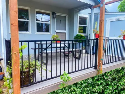 a porch with a black railing on a house at Sweet Home with Ample Parking Only 2mins to Freeway in Sacramento