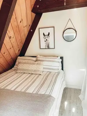 a bedroom with a bed with a picture of a dog at Mid Century Modern Cabin - The Tahoe A-Frame in Homewood