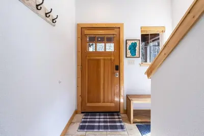 a hallway with a wooden door in a house at Bright 3BD Kings Beach Townhome in Kings Beach