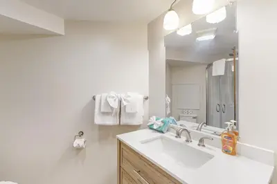 a white bathroom with a sink and a mirror at Sierra Park Villas 39 H in Mammoth Lakes