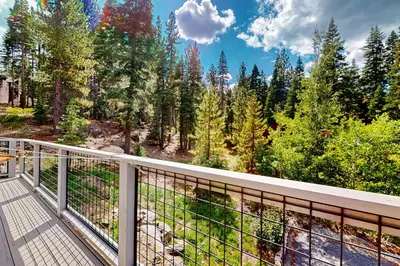 a balcony with a view of the woods at Zen Amongst the Trees in Truckee