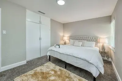 a bedroom with a large bed and a glass closet at Fun City Haven Spacious Retreat in Fresno in Fresno