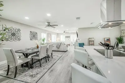 a dining room and living room with a table and chairs at Fun City Haven Spacious Retreat in Fresno in Fresno