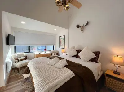 a bedroom with a large bed and a window at Gondola Chalet -New Luxury 5 Bdrm Condo @ Canyon Lodge, Steam Room in Mammoth Lakes