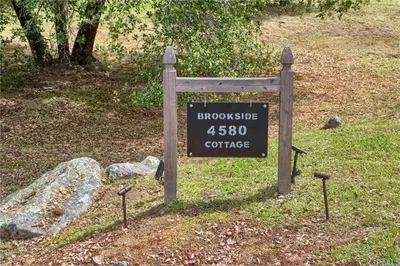 a sign for at Brookside Cottage in Mariposa