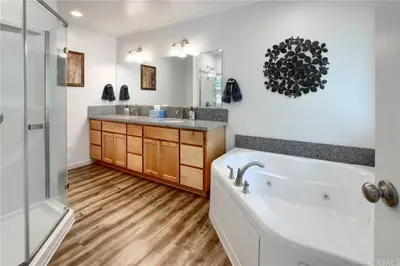 a bathroom with a tub and a sink and a shower at Brookside Cottage in Mariposa