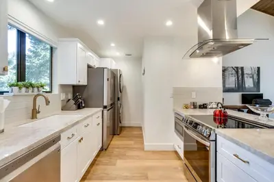 a kitchen with white cabinets and stainless steel appliances at Stylish Incline Village Vacation Rental with AandC! in Incline Village