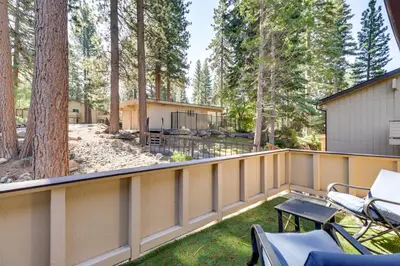 a balcony with a fence and a yard with a house at Stylish Incline Village Vacation Rental with AandC! in Incline Village